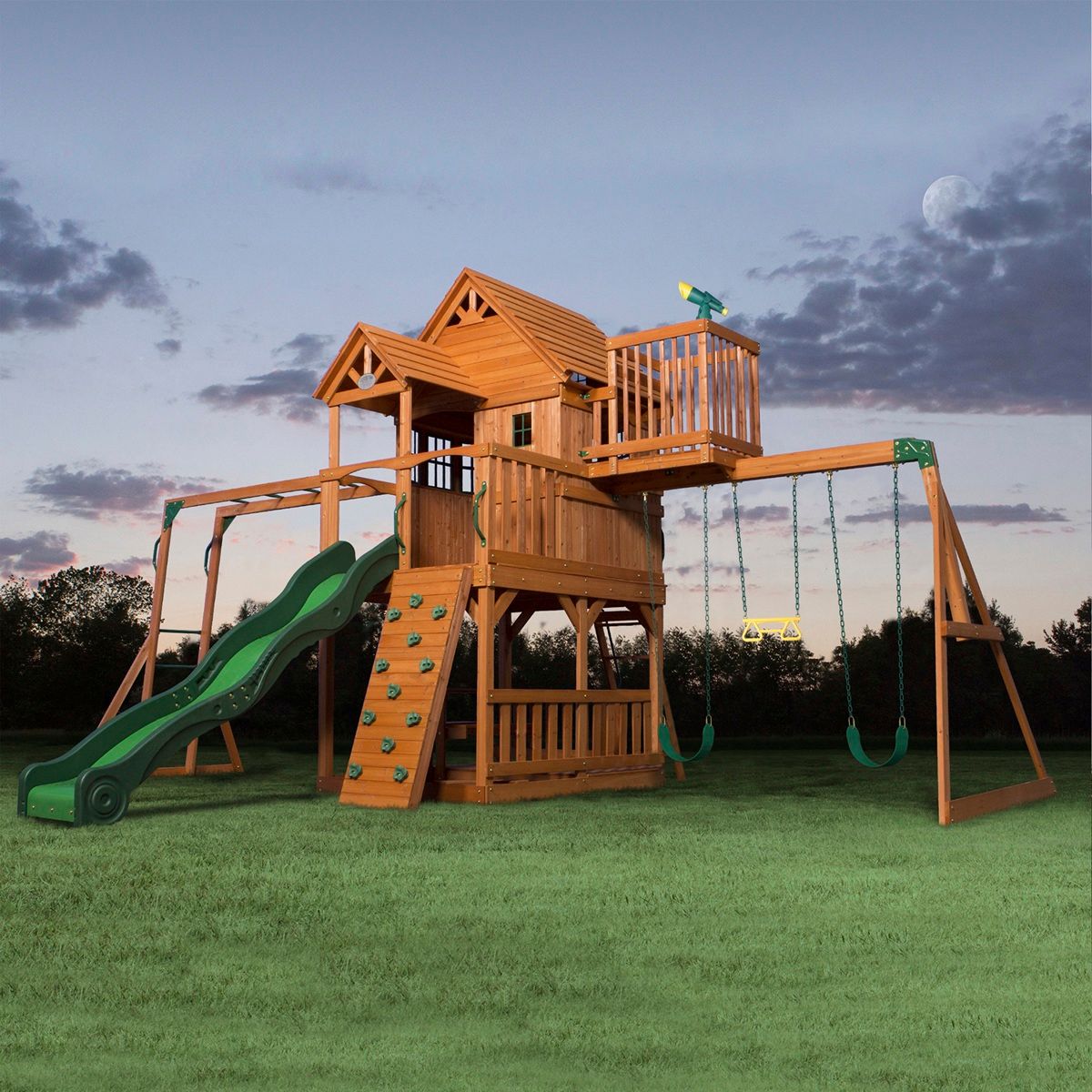 Wooden backyard playground at dusk with slides, swings, and climbing structures on a grassy lawn