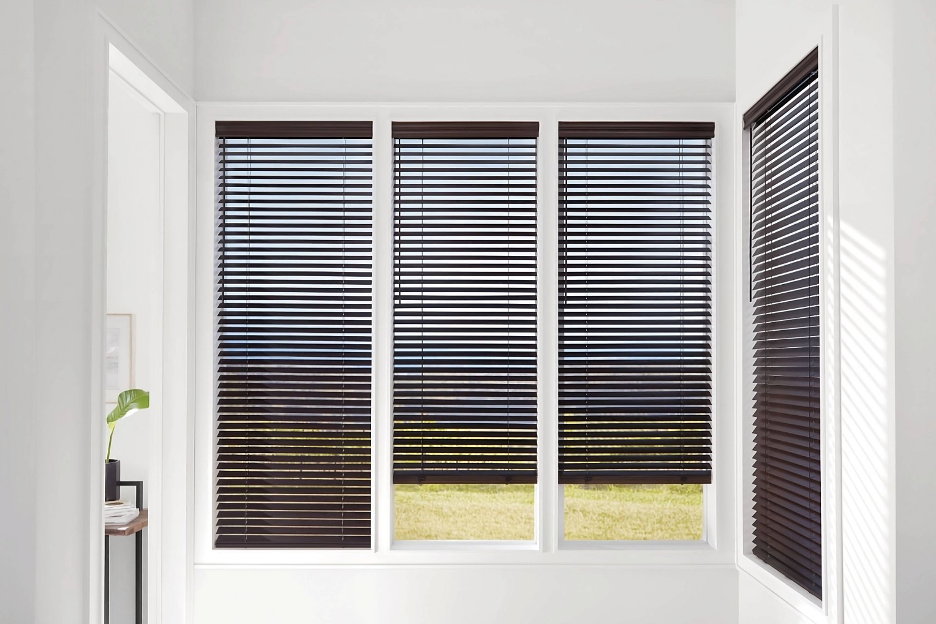 Dark brown Hunter Douglas Parkland® Wood Blinds on four windows in a home's hallway near Anchorage, 