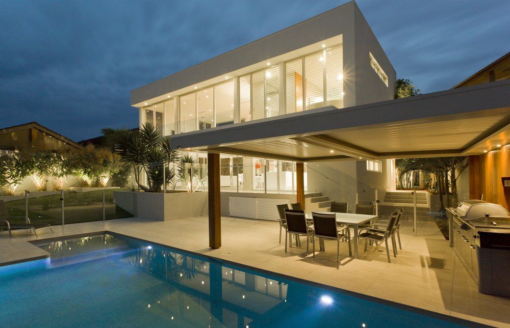 Modern House At Dusk With Swimming Pool — Coastline Property Wollongong  In Woonona, NSW