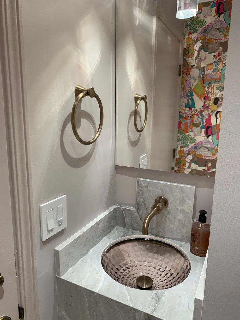 Custom powder room vanity, backlit sink and statement wallpaper