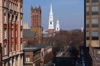 A view of a city street with a church in the background.