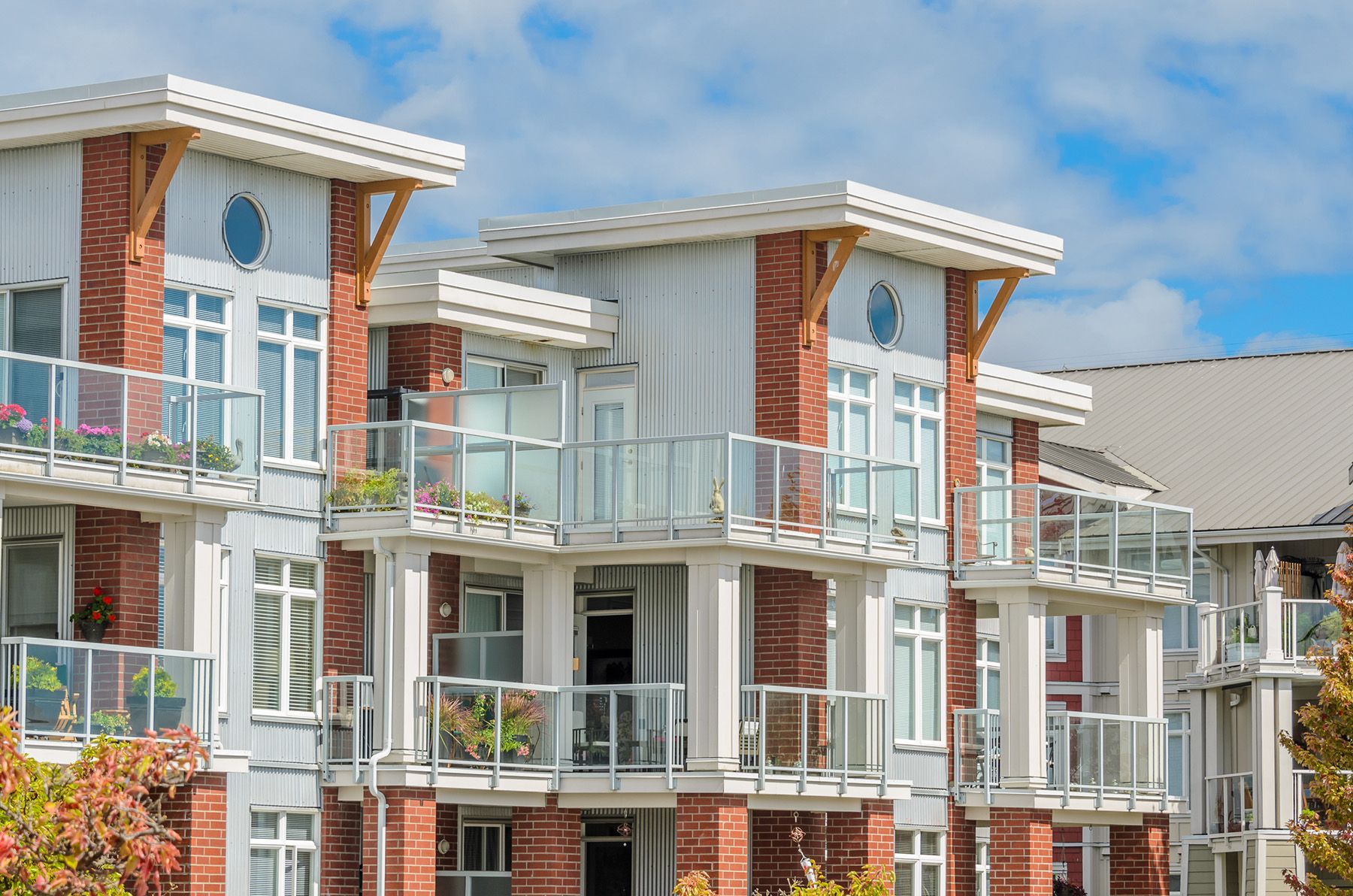 A row of apartment buildings with balconies on a sunny day.