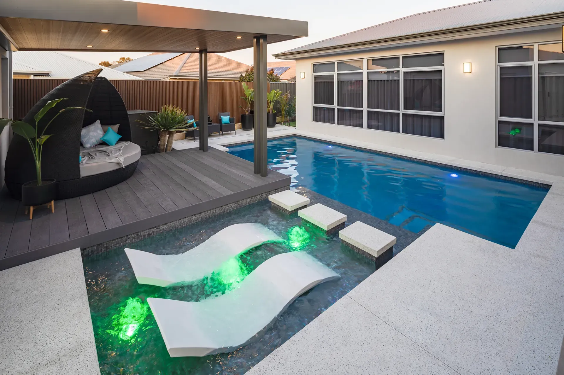 A large swimming pool in the backyard of a house