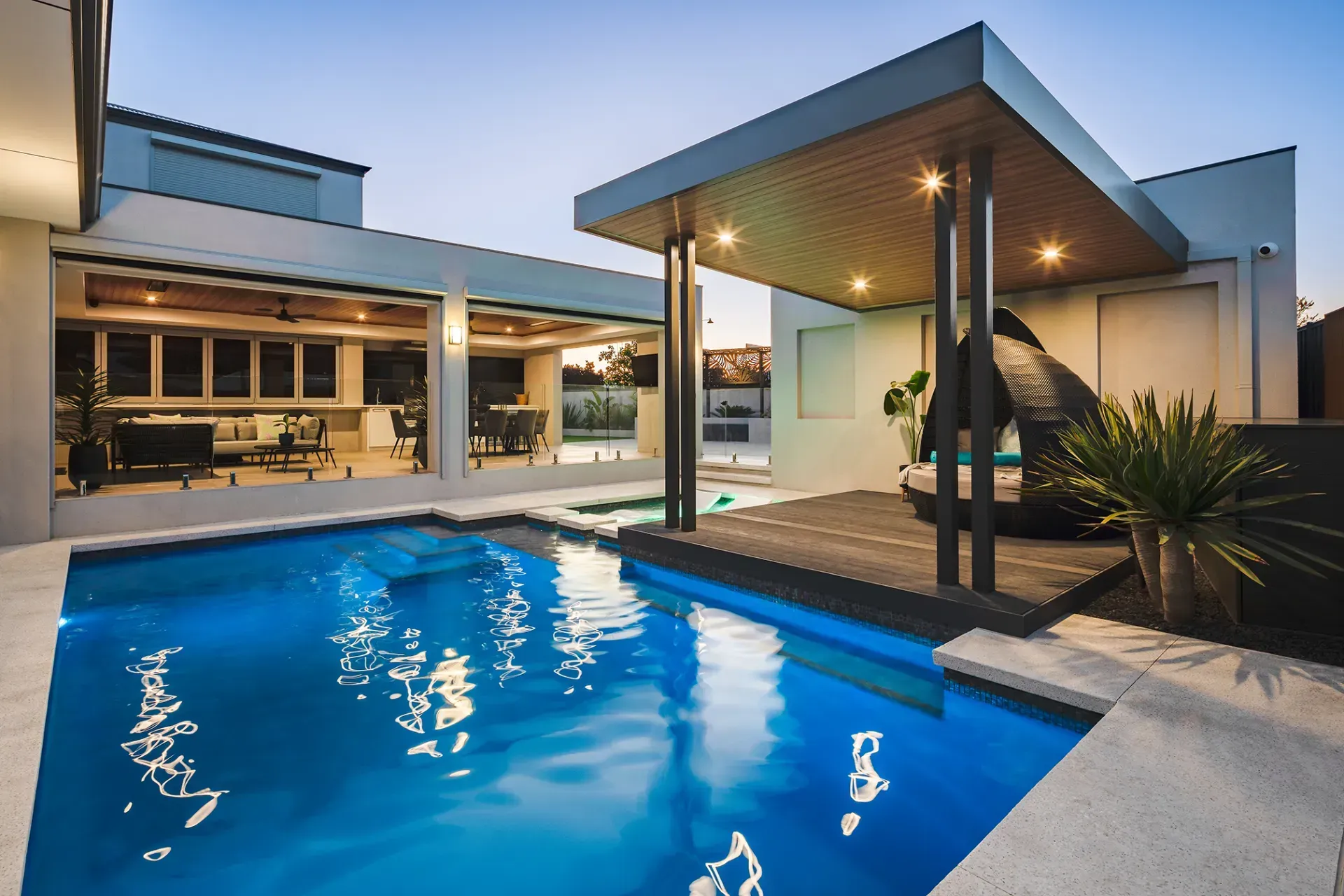 A large swimming pool in the backyard of a house