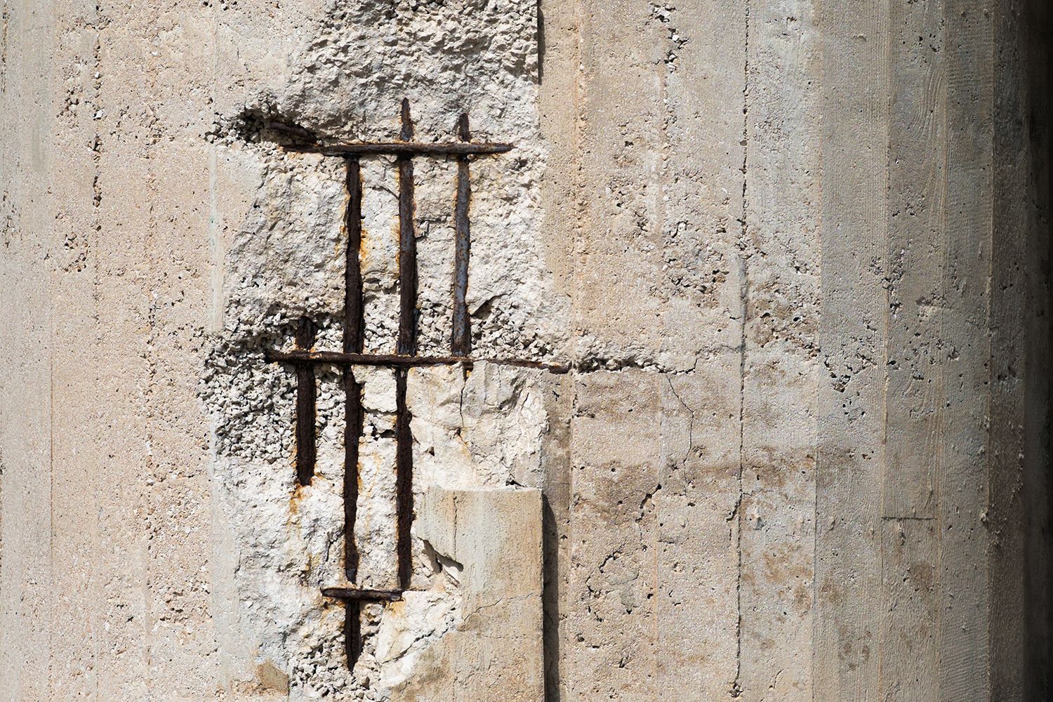 damaged concrete with exposed steel bars
