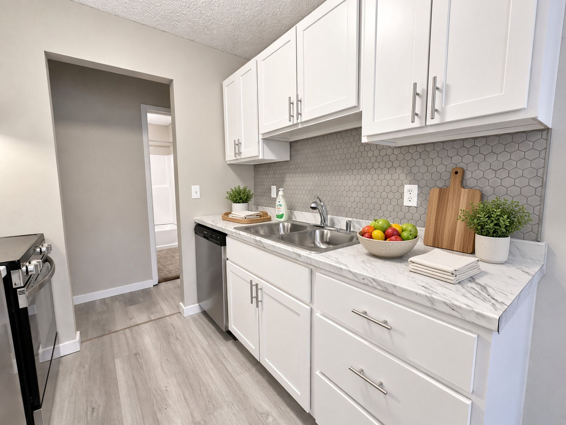 Renovated kitchen with white cabinets at The Groves