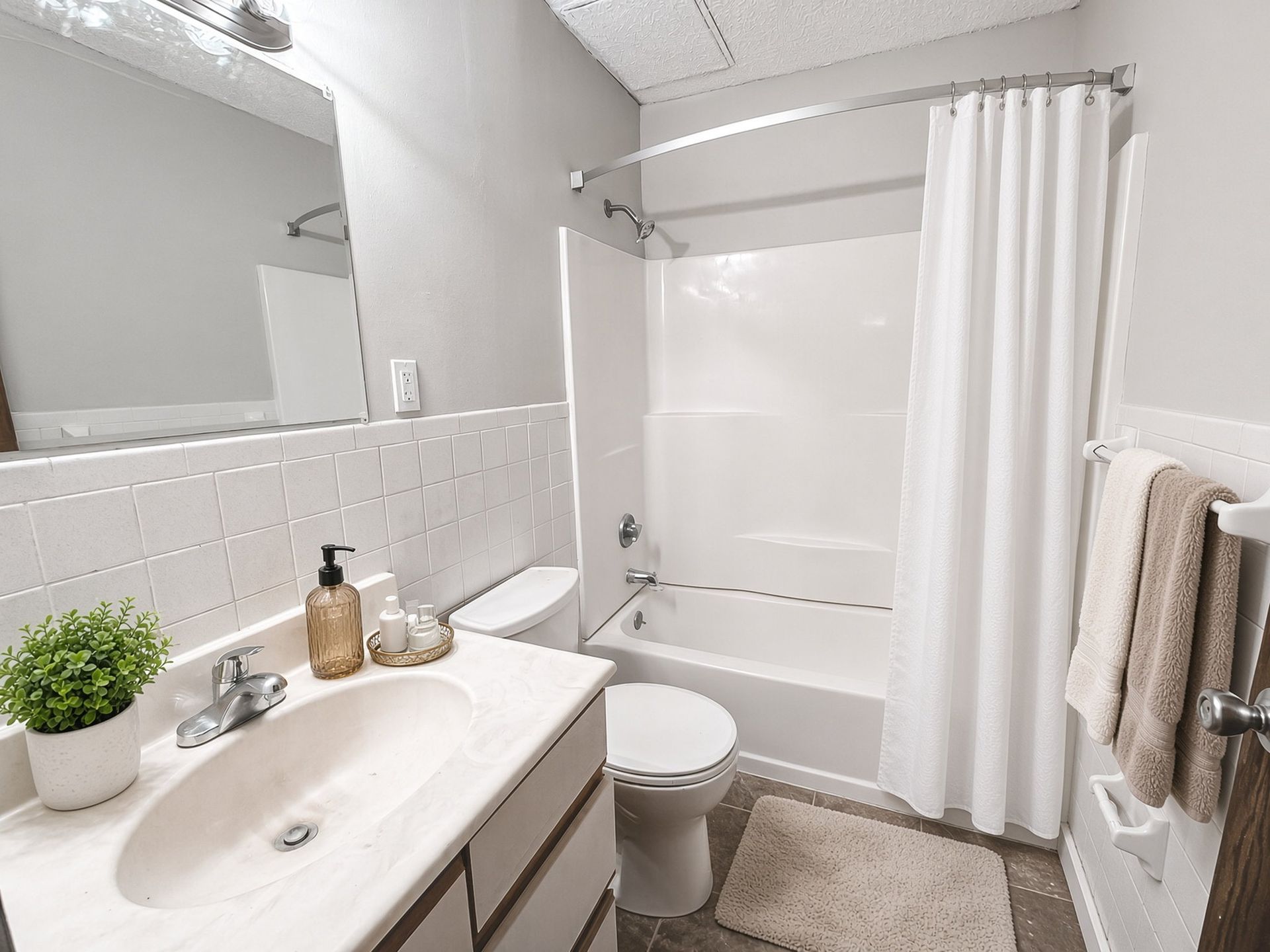 Bathroom with tub and shower at The Groves apartments, Brooklyn Park MN
