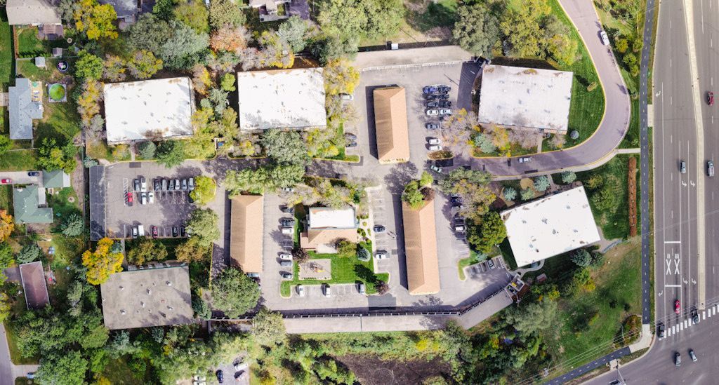 An aerial view of a residential area with lots of trees and buildings.