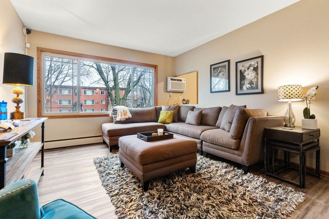A living room with a large sectional couch and ottoman