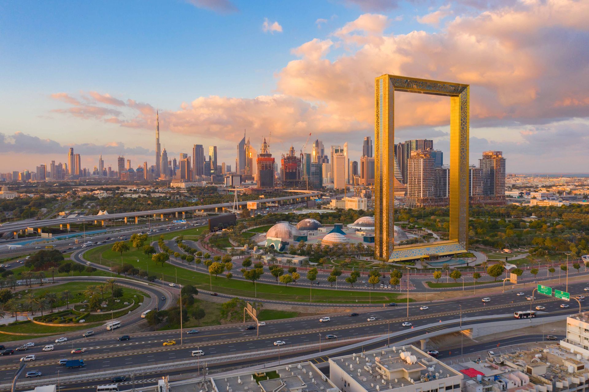 An aerial view of a city skyline with a golden frame in the foreground.