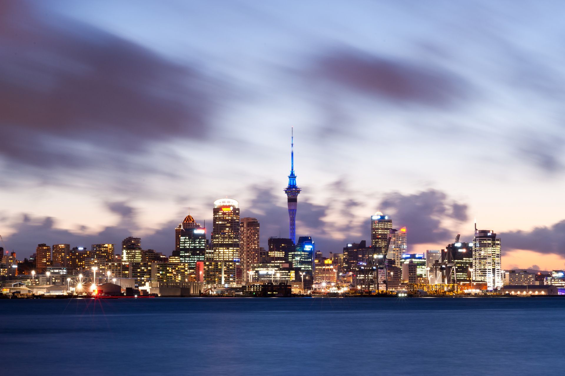 Dusk view of Auckland Skyline in New Zealand from the water.