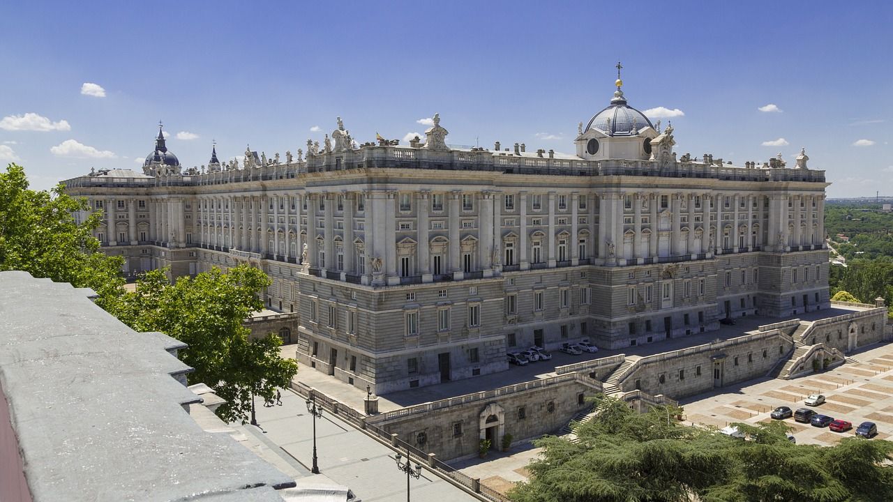 A large building with a dome on top of it is surrounded by trees.