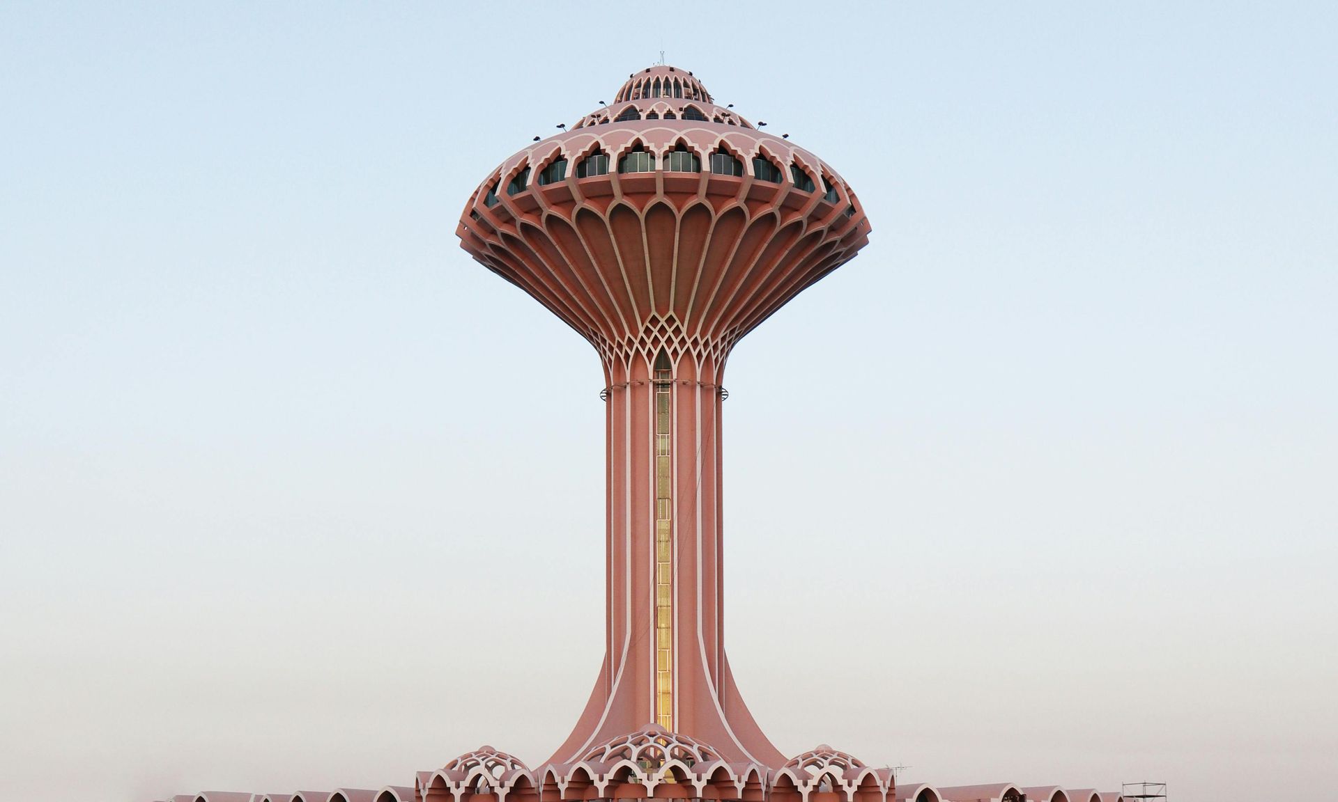 A large white mosque with palm trees in front of it