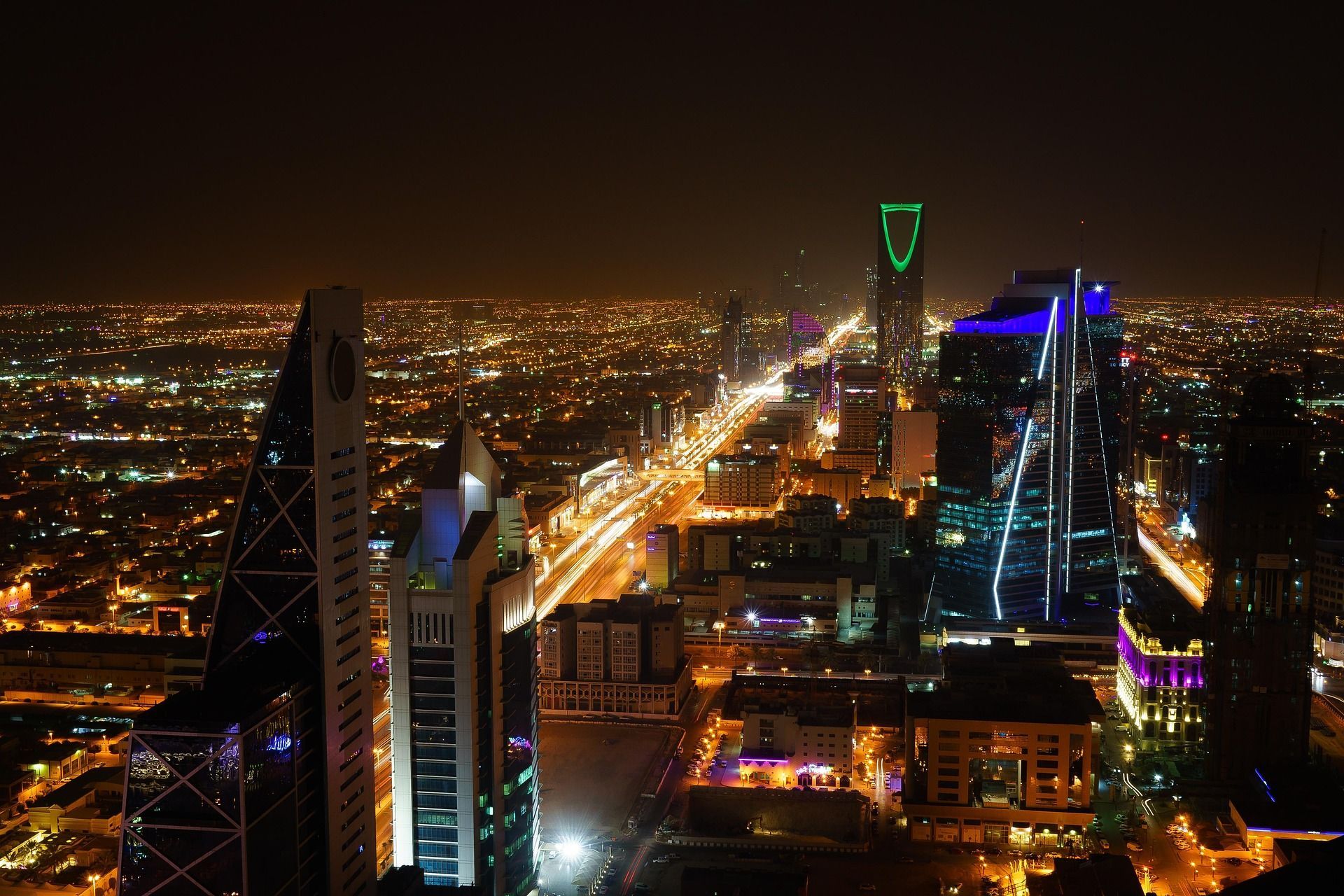 A close up of a tall building at night.
