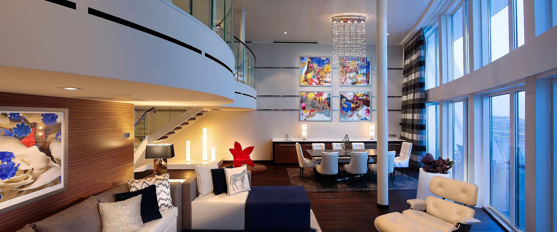 A living room with a lot of windows and furniture.