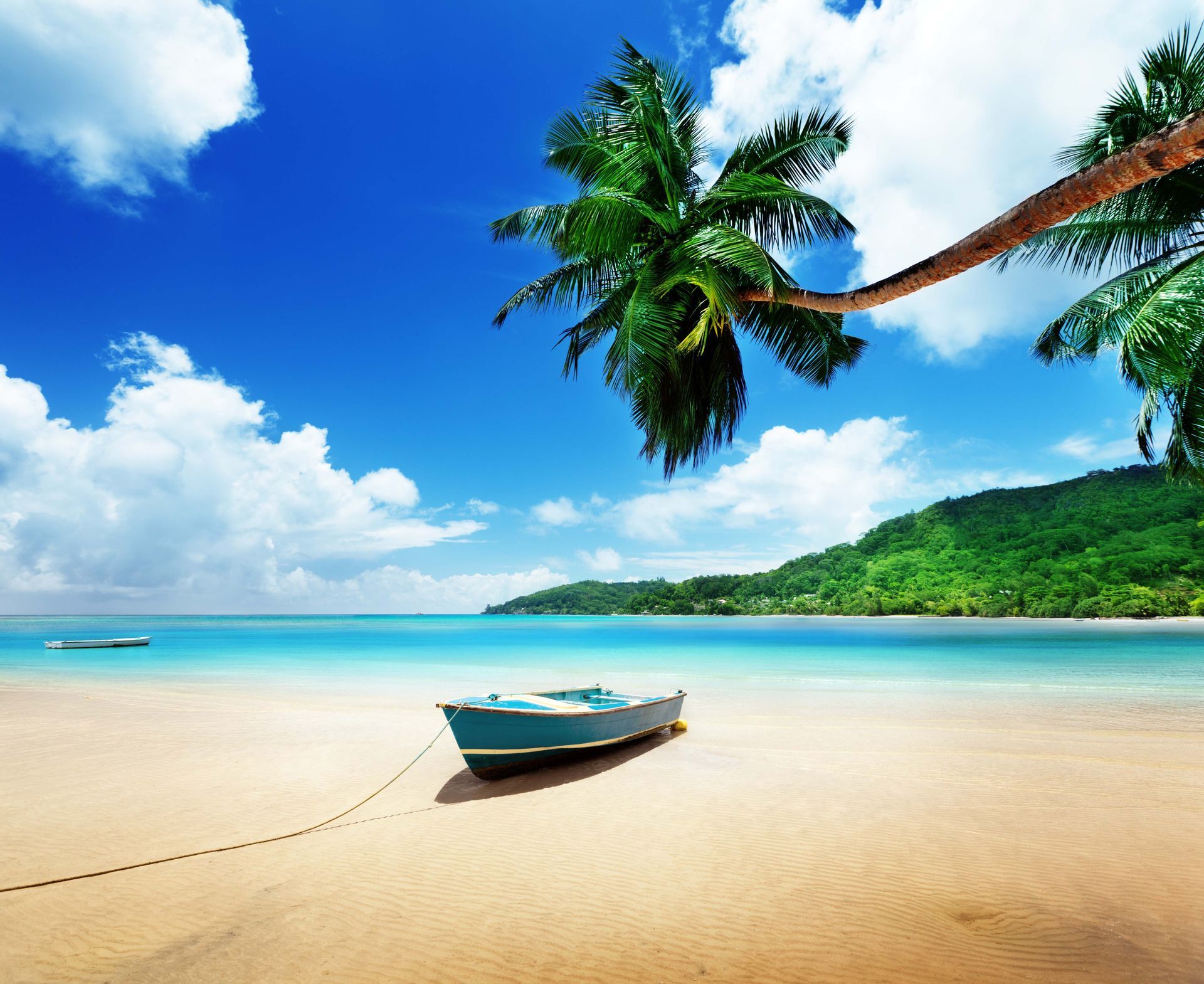 A tied boat on the sand at Mahe island in Seychelles, Indian Ocean.