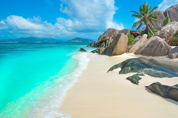 White beach and blue water of Anse Source d'Argent, a beach in Seychelles, Indian Ocean.