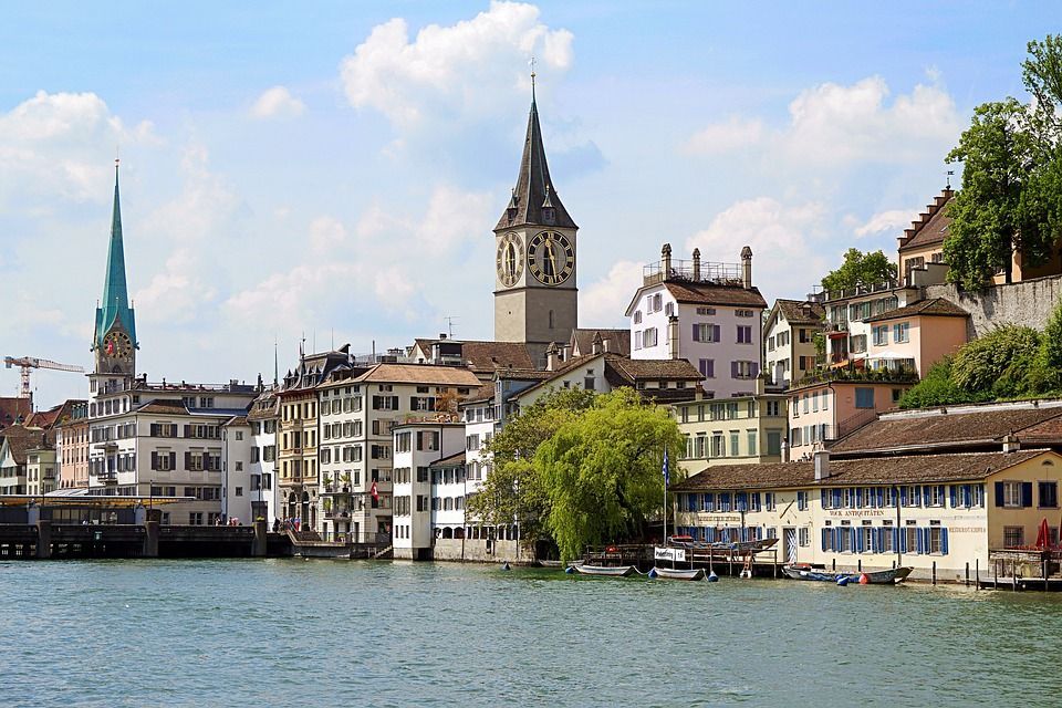 St. Peter's church in Zurich, Switzerland with the river Limmat in the foreground.