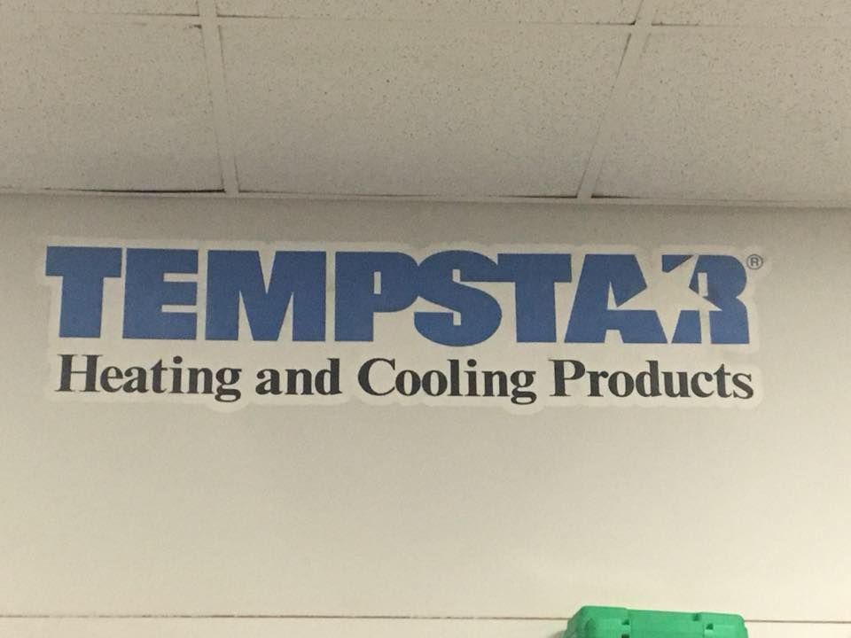 Tempstar logo on a white wall, text in blue: Heating and Cooling Products.
