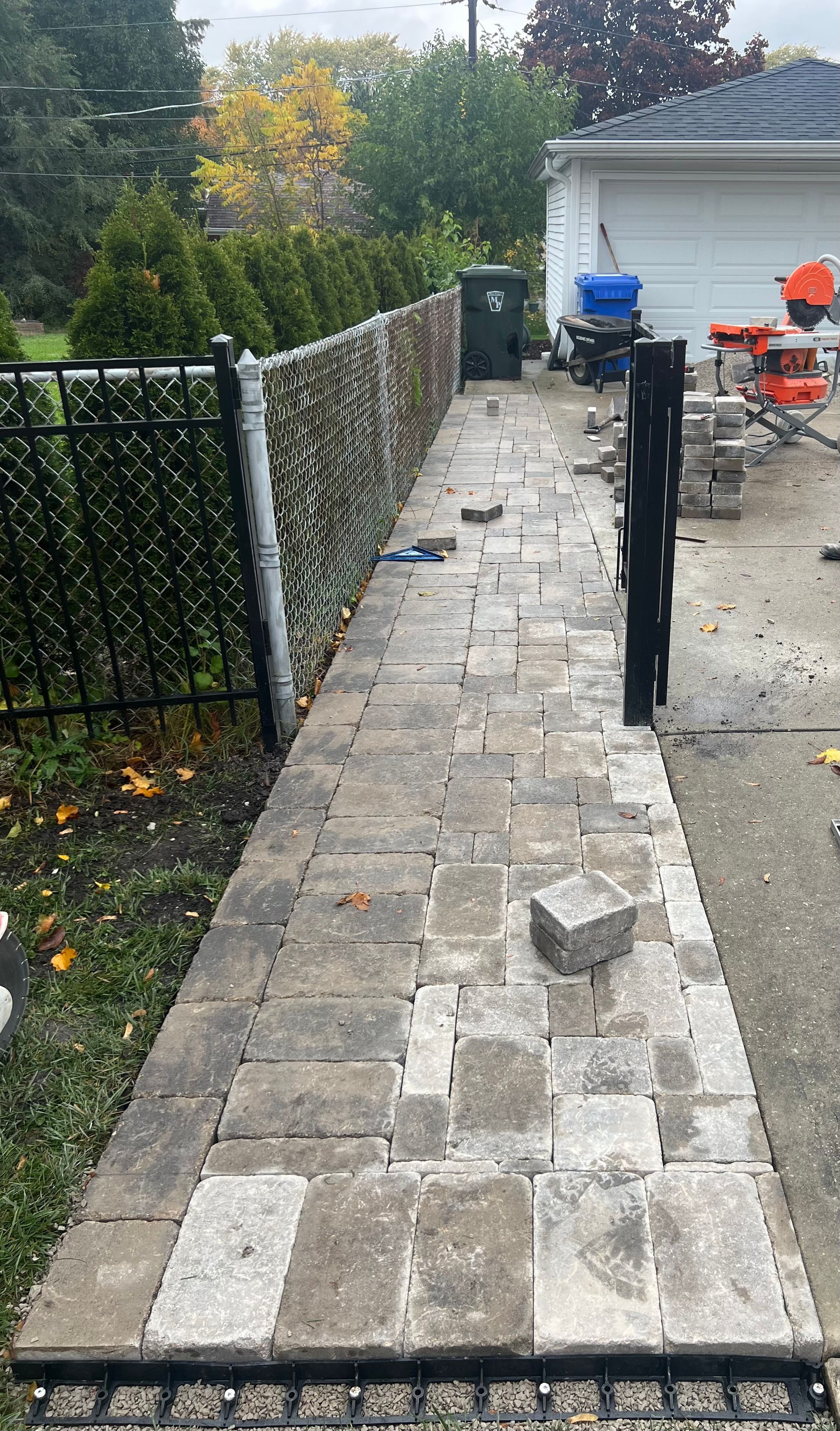 A sidewalk is being built in front of a house.