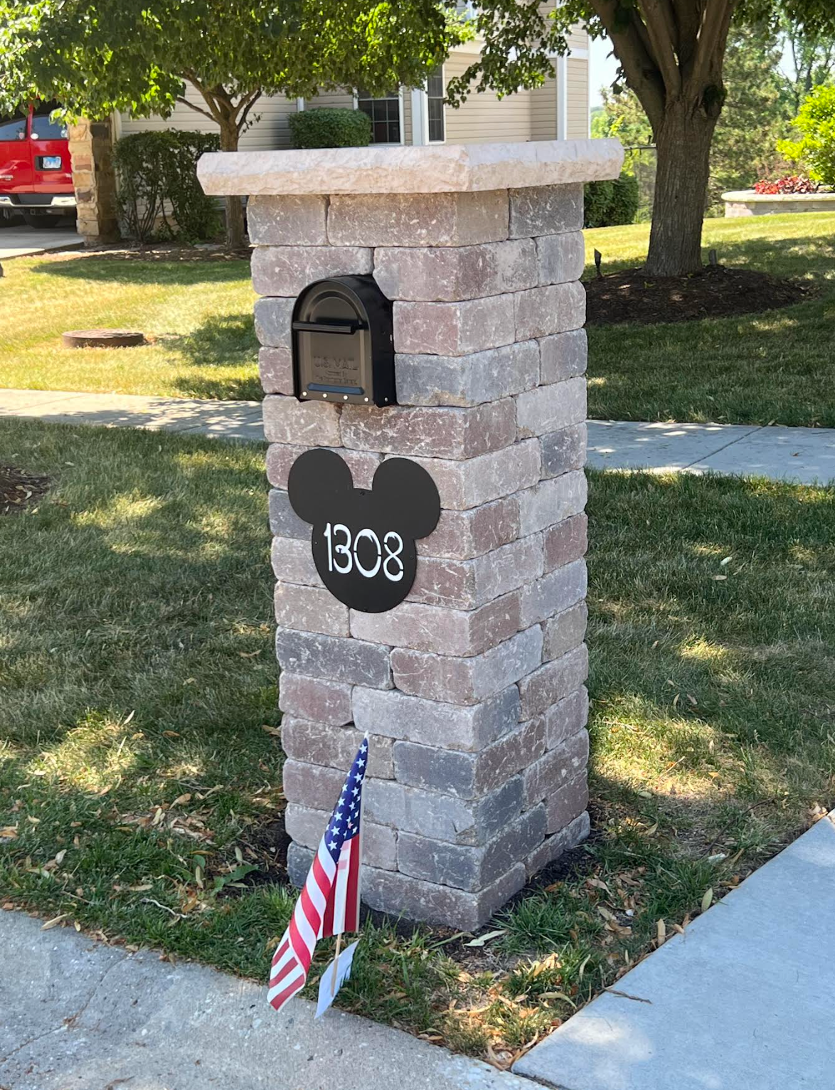 A brick mailbox with a mickey mouse head on it