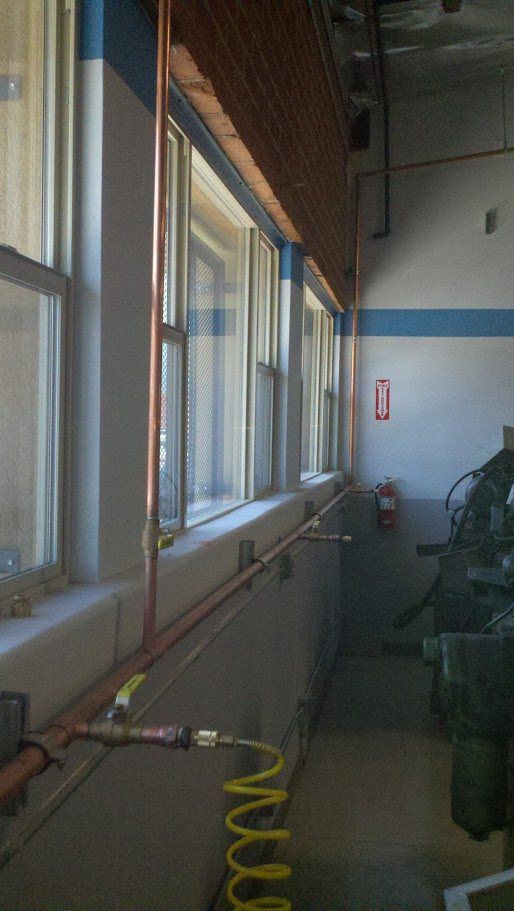 A room with a lot of windows and a machine in it.
