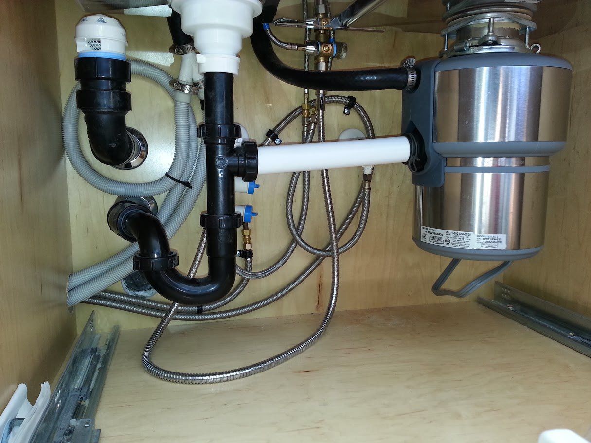 A sink with a garbage disposal underneath it