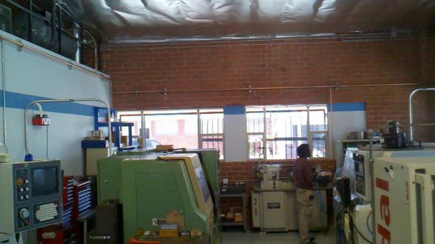 A man is working on a machine in a factory.