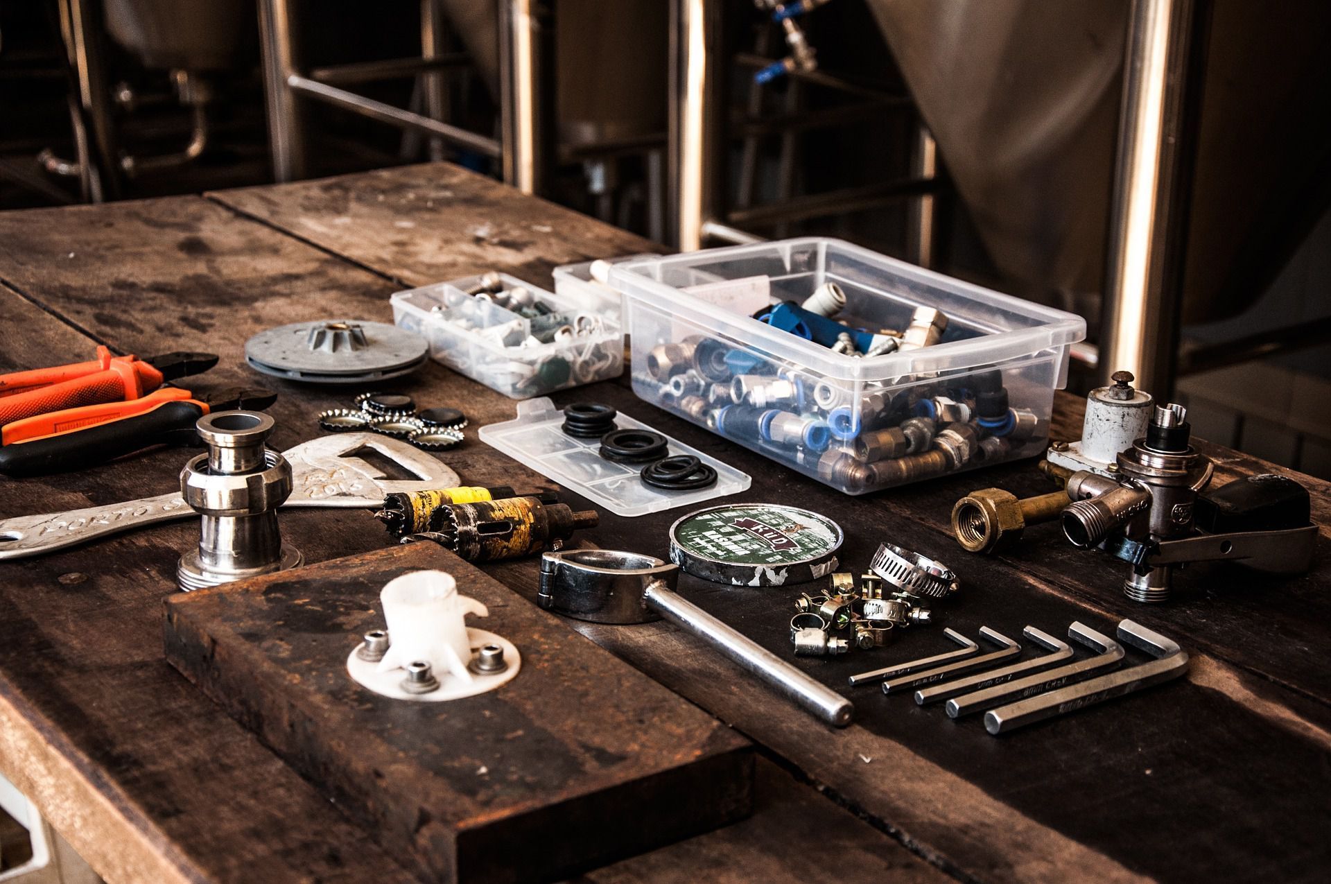 A wooden table topped with a variety of tools and nuts.