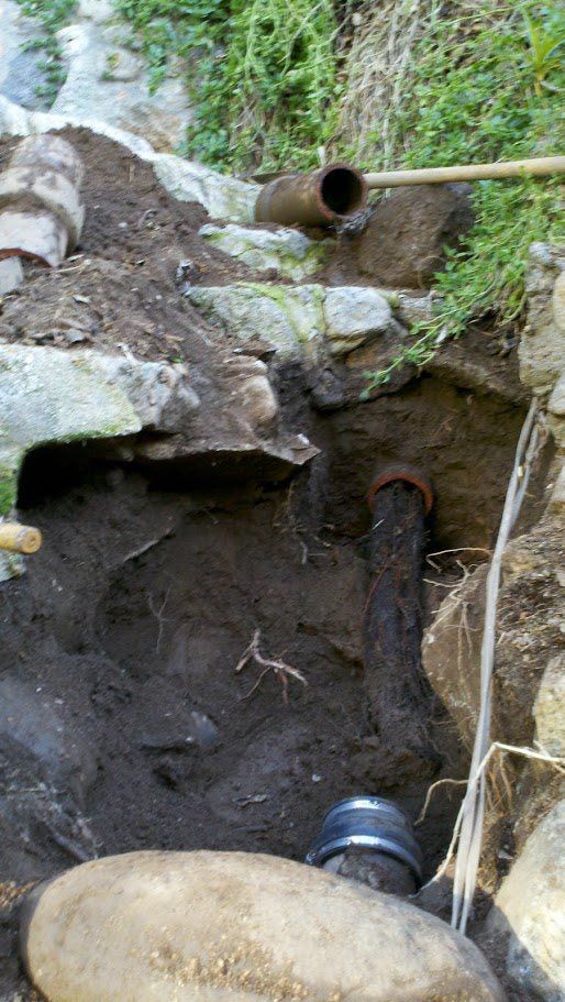 A pipe is coming out of a hole in the ground.