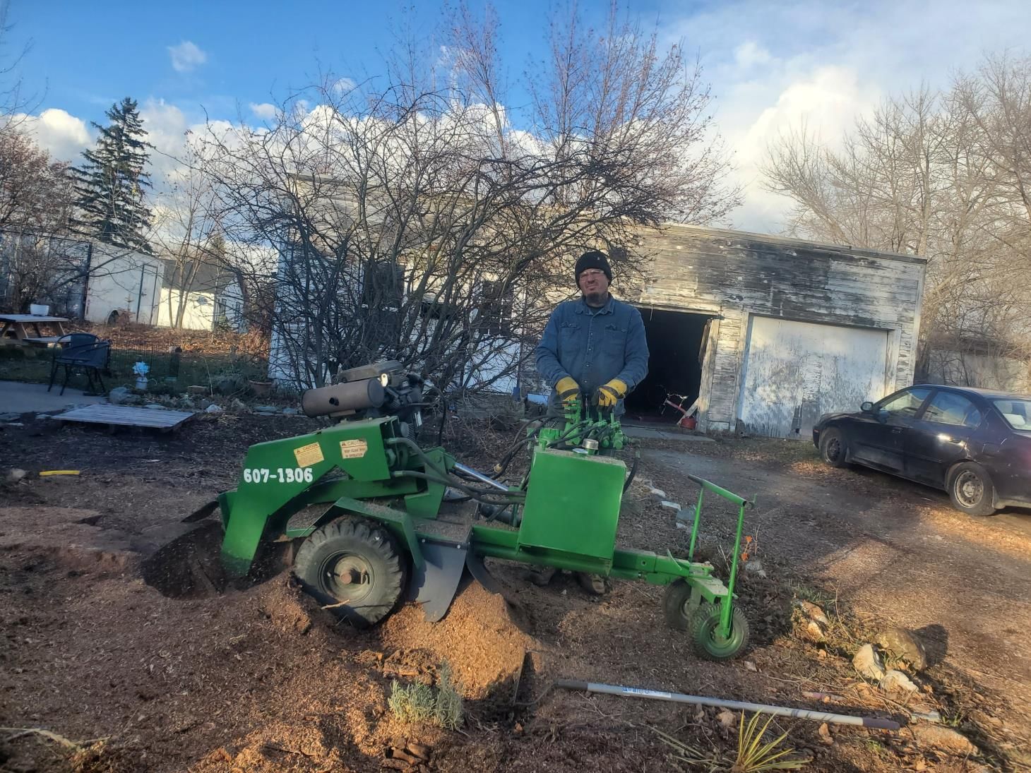 a yellow machine is stump grinding a tree stump