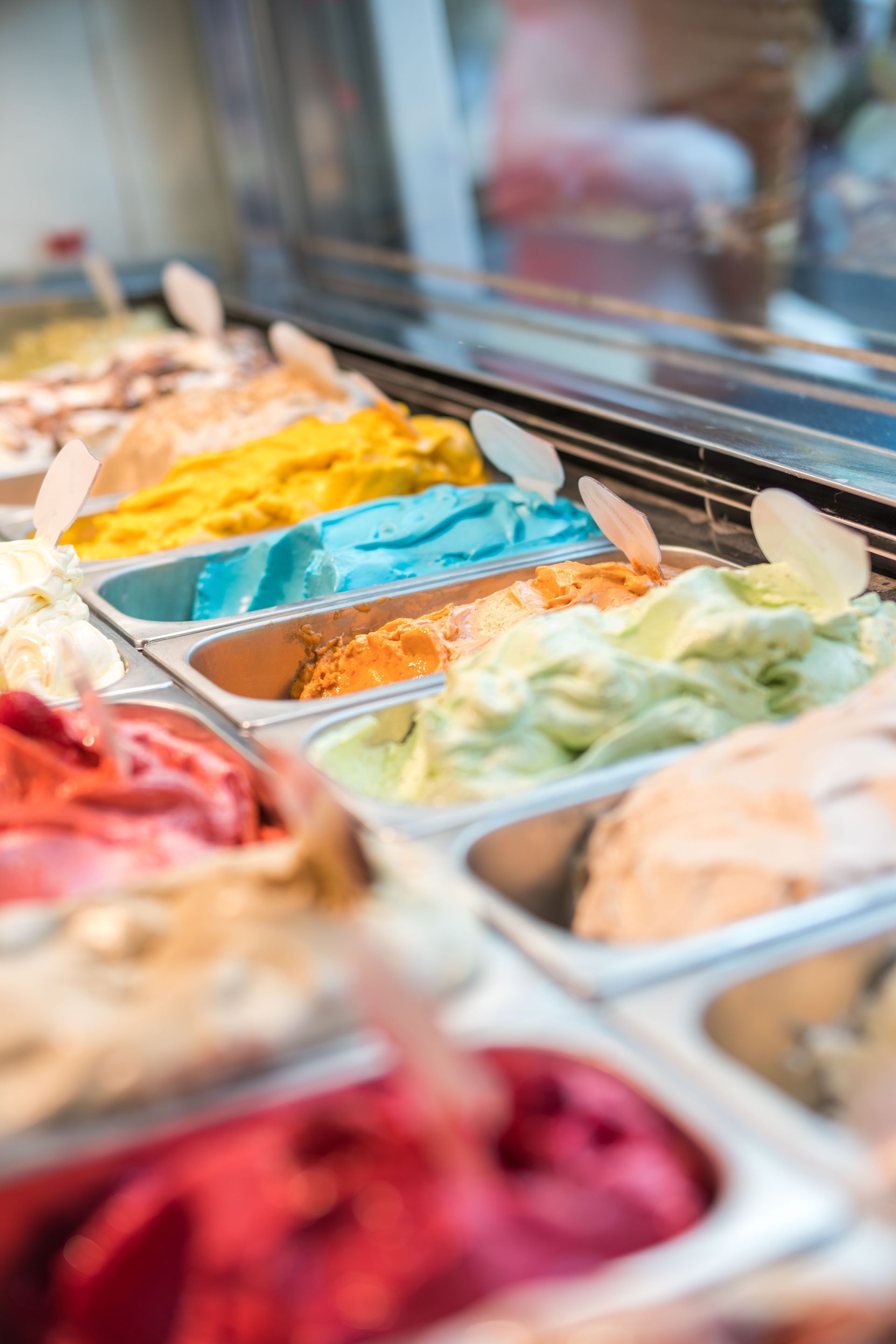 Colorful trays of gelato in a shop display case