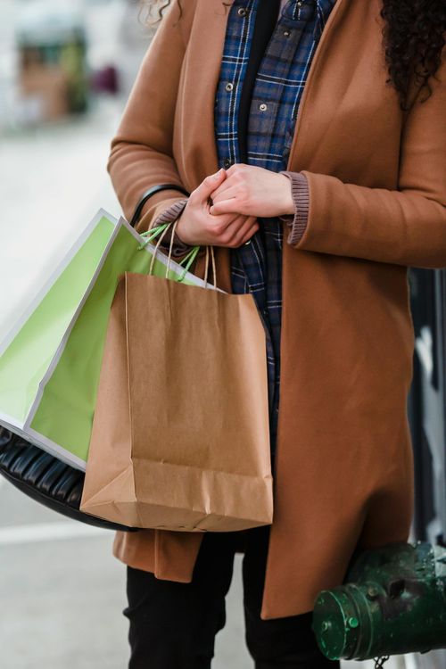 Person shopping with bags near Lake St. Clair and Anchor Bay