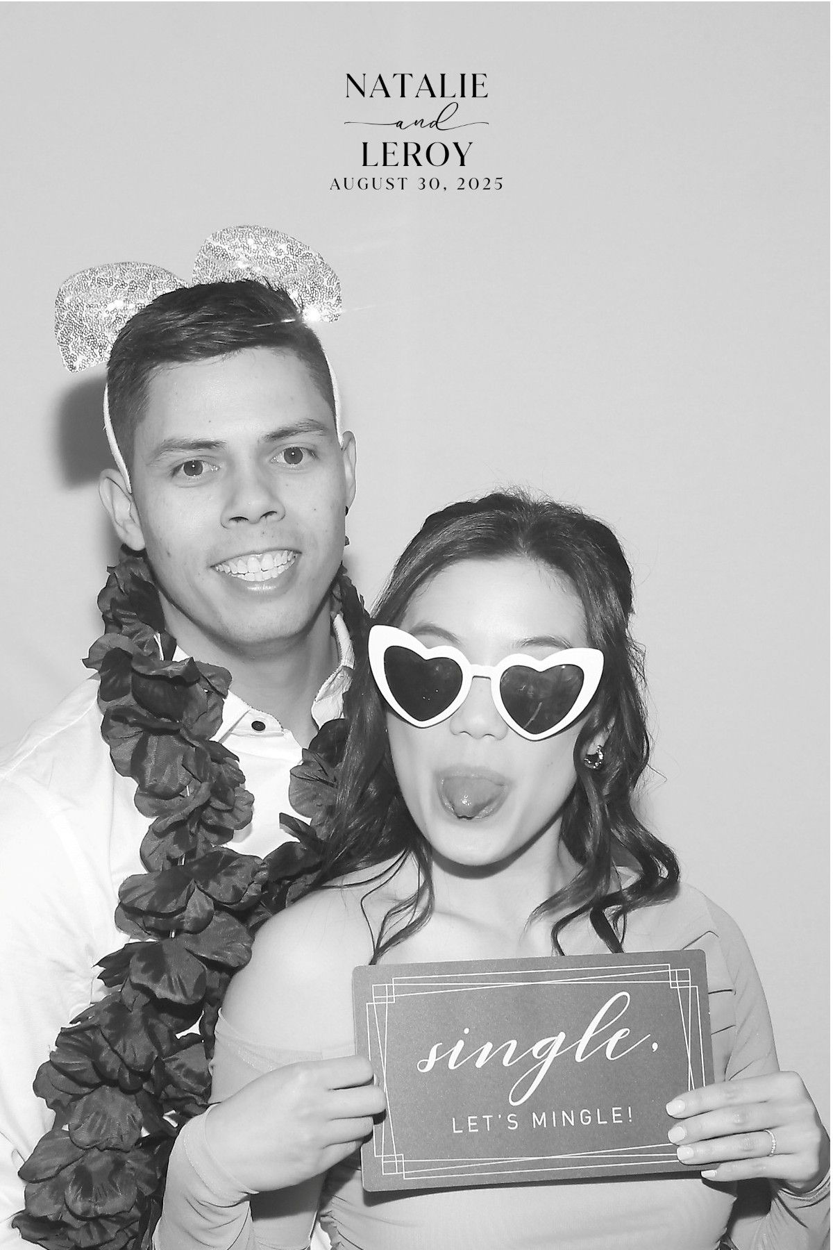 A black-and-white photo booth strip of a couple wearing party props. The person on the right holds a
