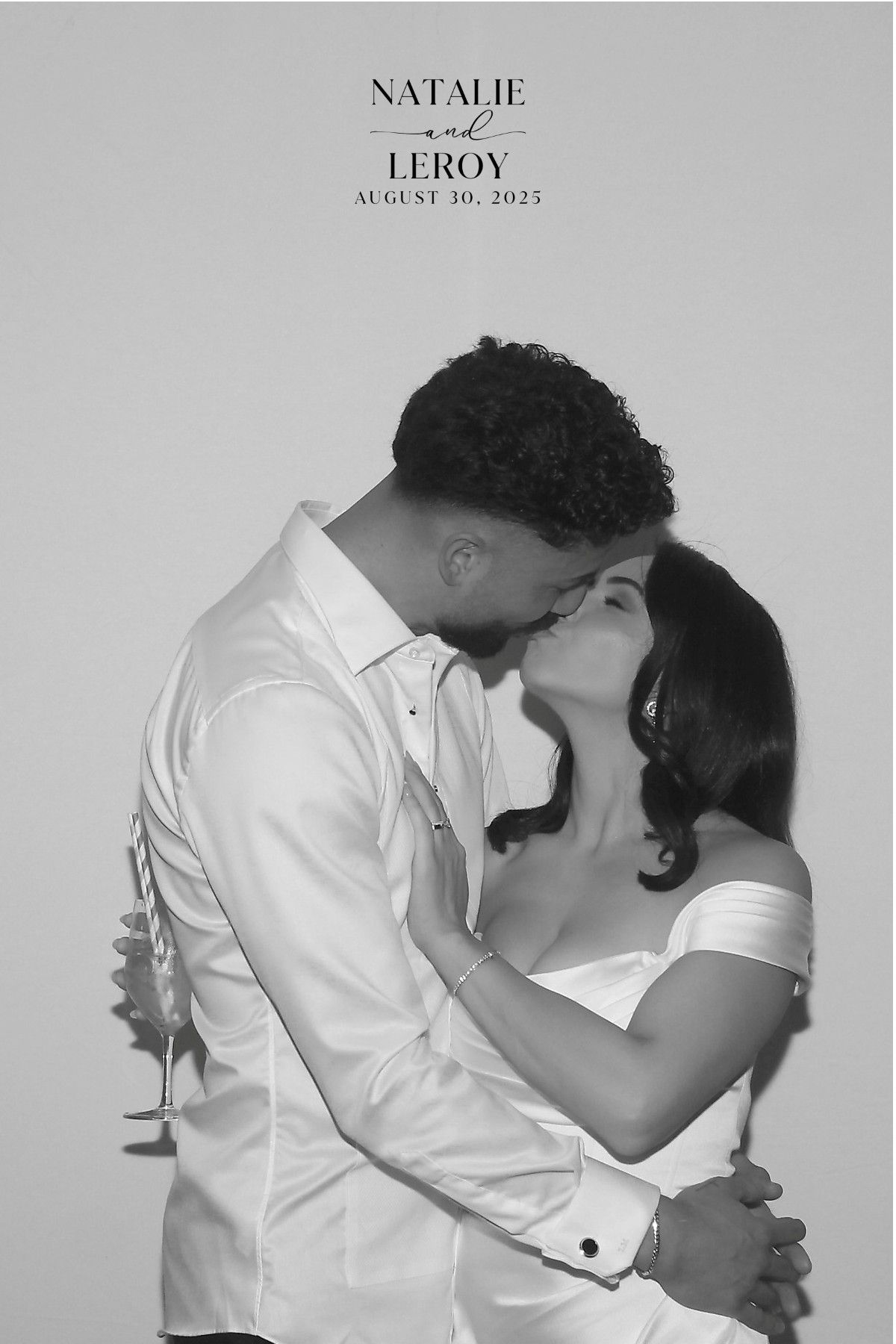 A couple embraces and shares a kiss in front of a plain background, with text above reading