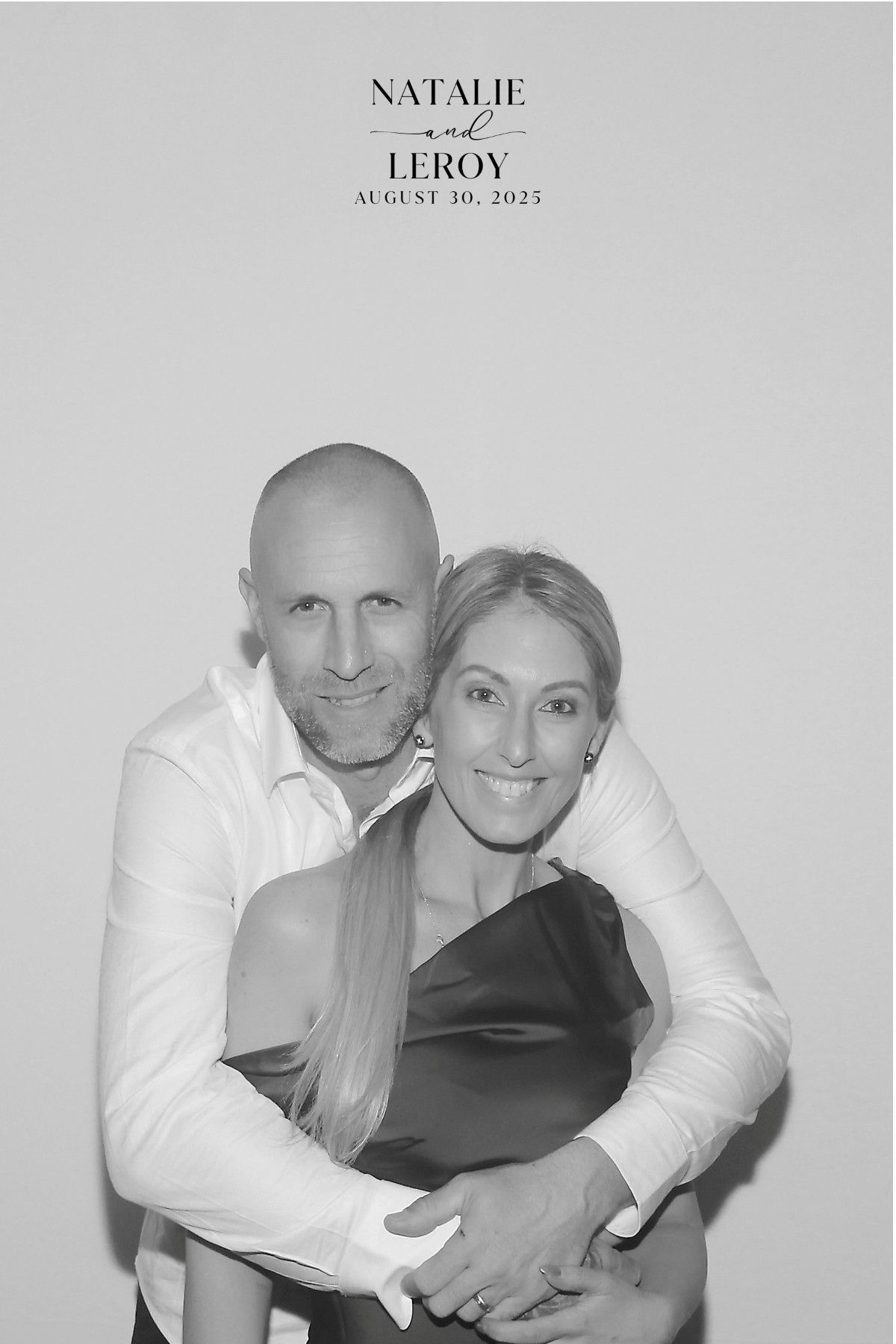 A smiling couple posed for a wedding photo with a text overlay saying,