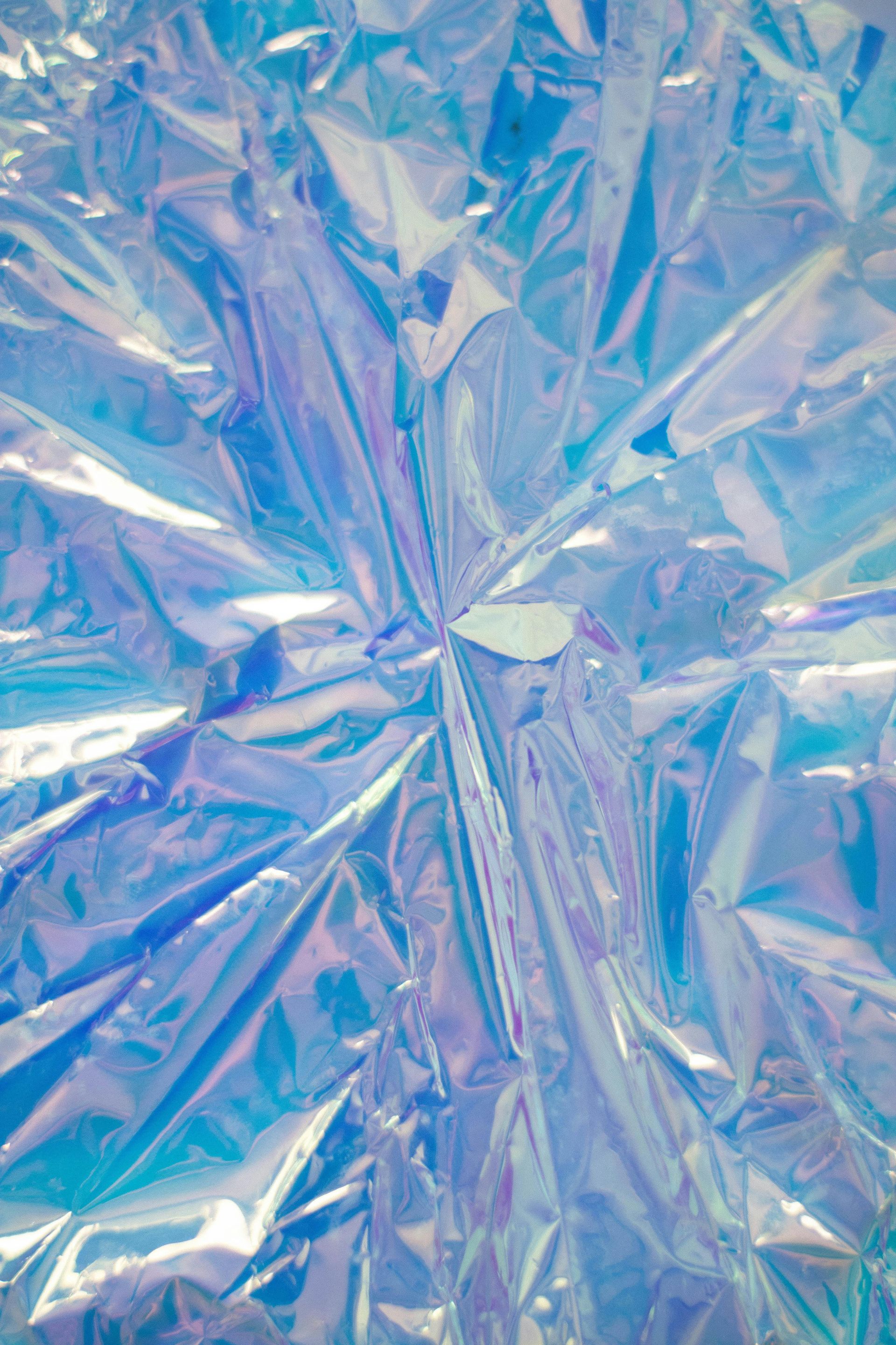 Crinkled iridescent blue and white foil texture.