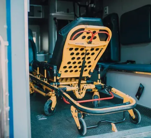 An ambulance with a stretcher in the back of it.