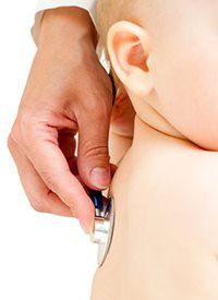 Doctor using a stethoscope on a baby's chest.