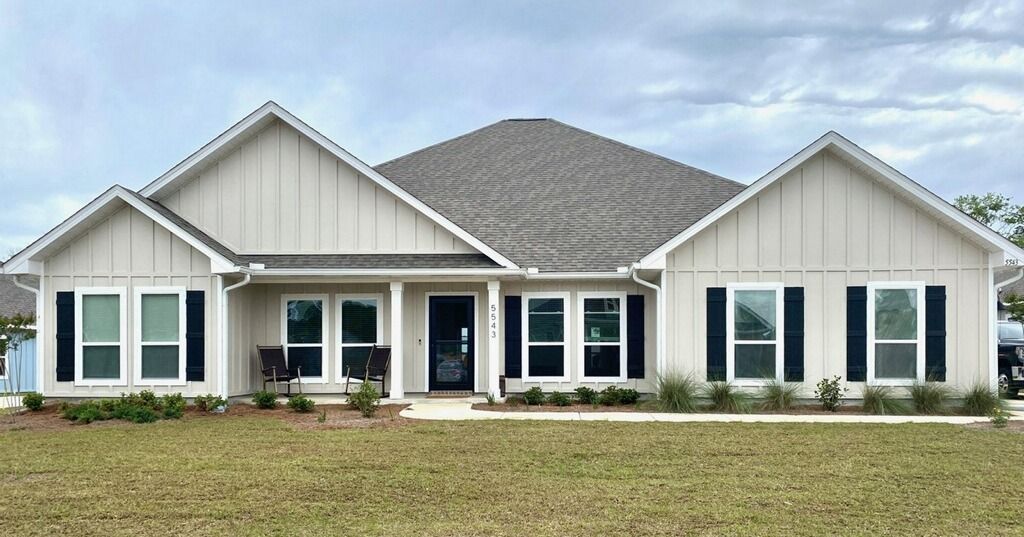 A large white house with a gray roof and black shutters - Milton, FL - Damn Fine Jobs
