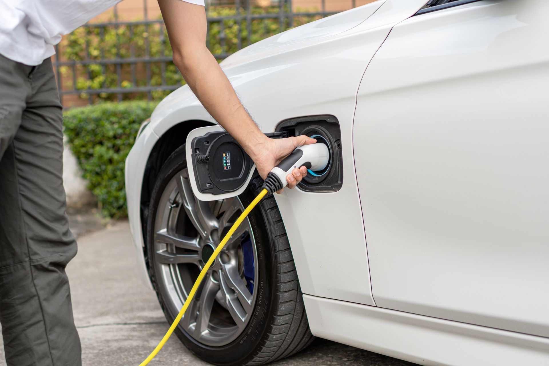 A person is charging an electric car with a charger - Milton, FL - Damn Fine Jobs