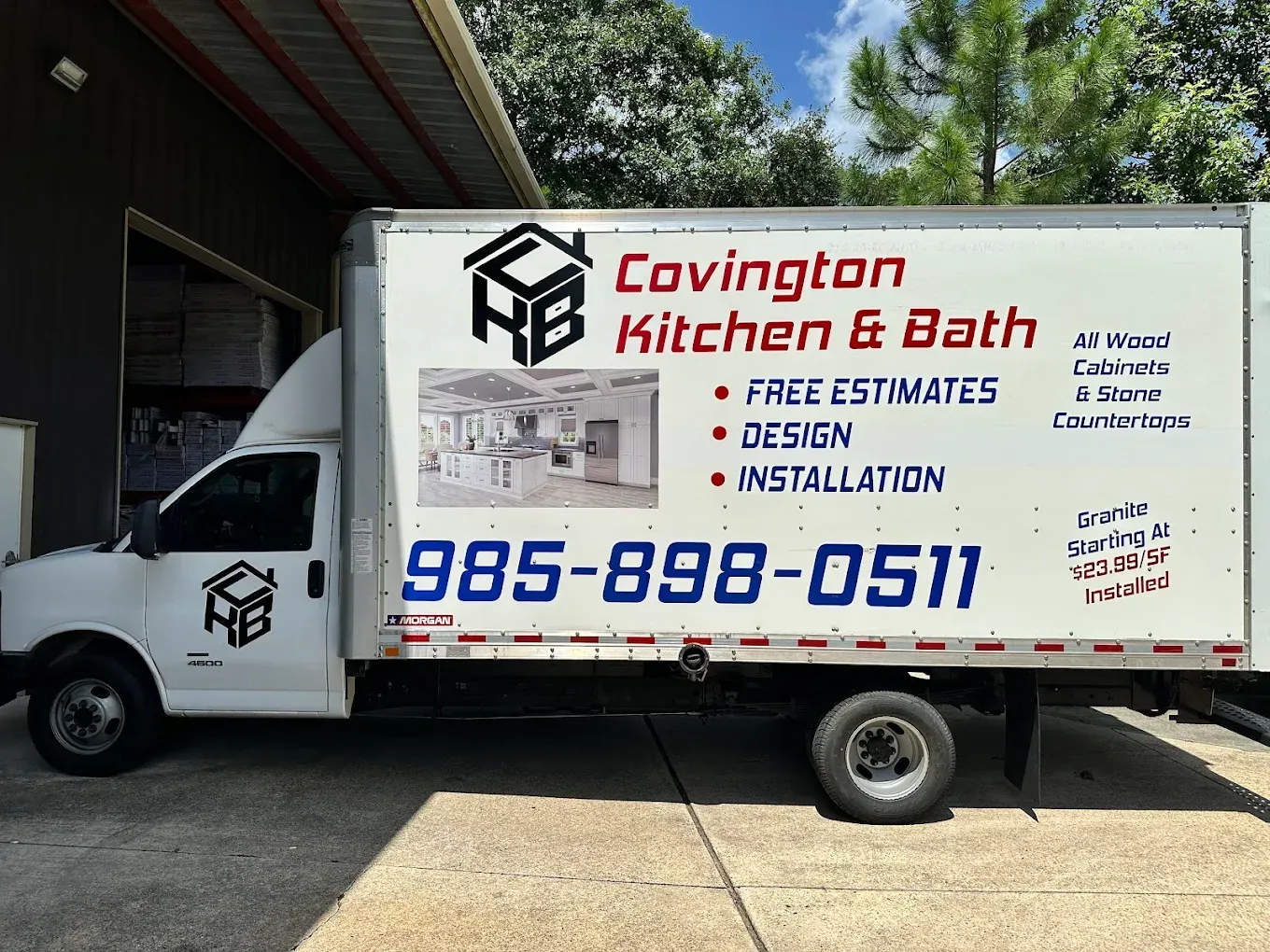 Covington Kitchen & Bath service truck with contact number and “Free Estimates” text parked by a building