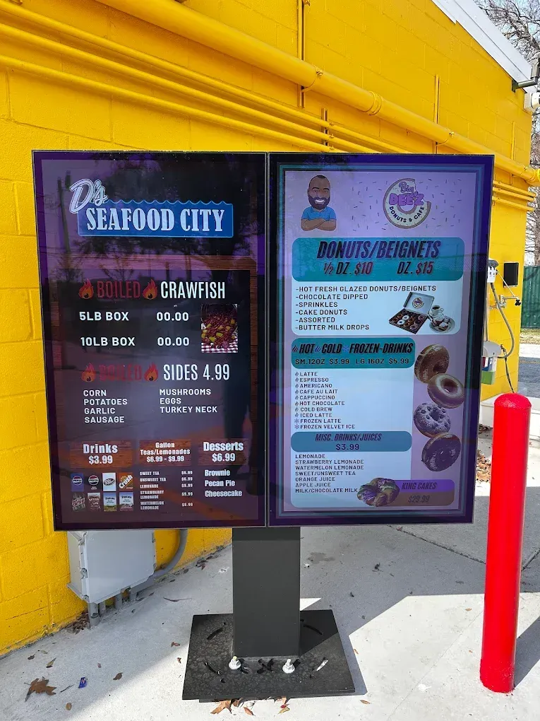 Seafood City restaurant menu board with purple panels beside a yellow wall and red bollard