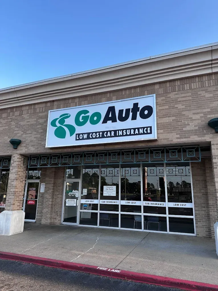 GoAuto insurance storefront with green-and-white sign above glass entrance in a strip mall