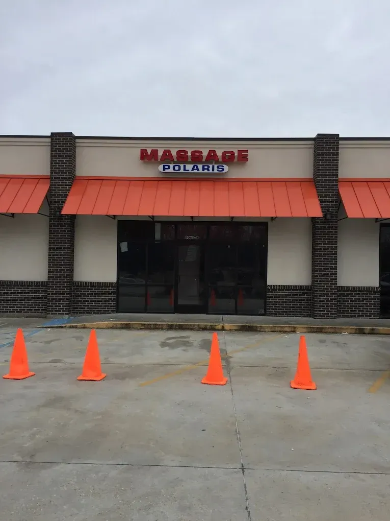 Storefront with orange awnings and cones blocking the entrance