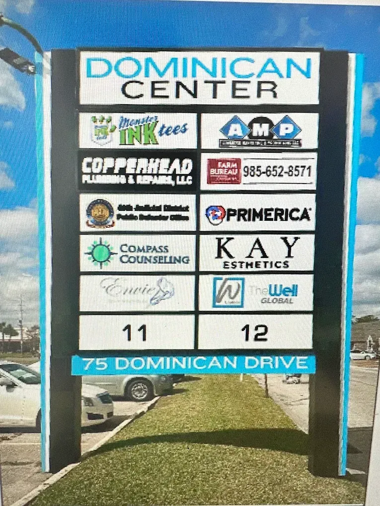 Dominican Center directory sign with business logos and suite numbers at 75 Dominican Drive