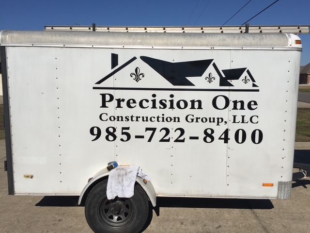 White Precision One Construction Group trailer with logo and phone number