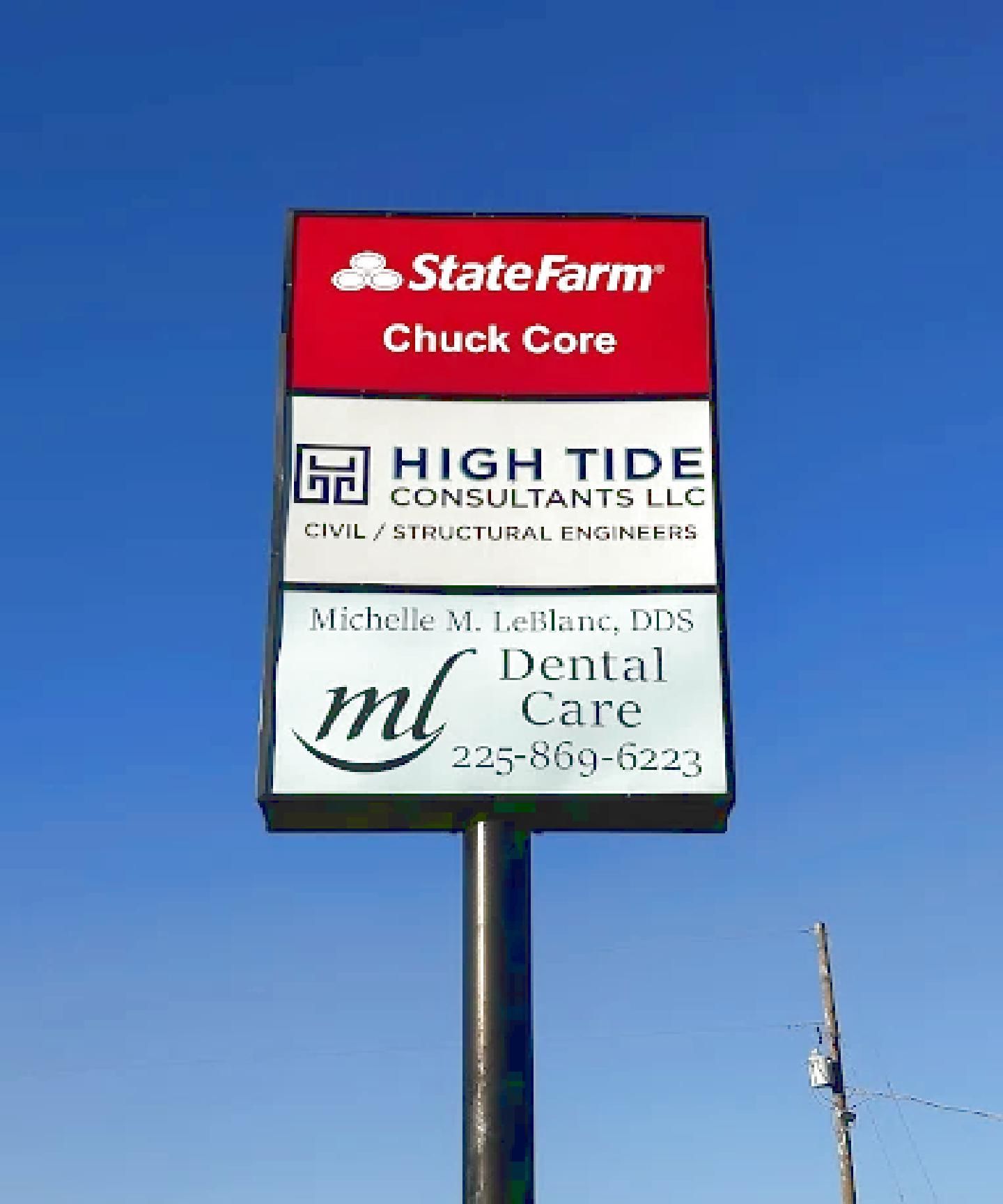 Tall roadside business sign with State Farm, High Tide Consultants, and Dental Care ads against a blue sky