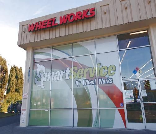 Wheel Works storefront with SmartService signage on a glass facade