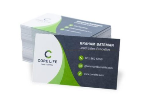 Stack of Core Life business cards with green and dark gray design showing Graham Bateman’s contact details